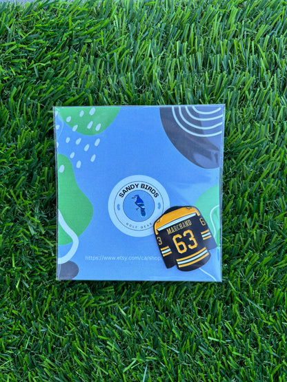 Sandybirds Golf Gear Marchand Ball Marker - Premium quality golf ball marker made of zinc alloy, designed in the shape of a Marchand jersey. A perfect accessory for golf enthusiasts looking to add a touch of style and precision to their game.