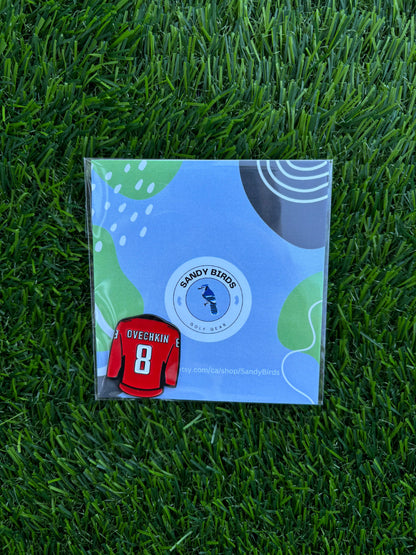 Sandybirds Golf Gear Ovechkin Ball Marker - Premium quality golf ball marker made of zinc alloy, designed in the shape of an Ovechkin jersey. A perfect accessory for golf enthusiasts looking to add a touch of style and precision to their game.