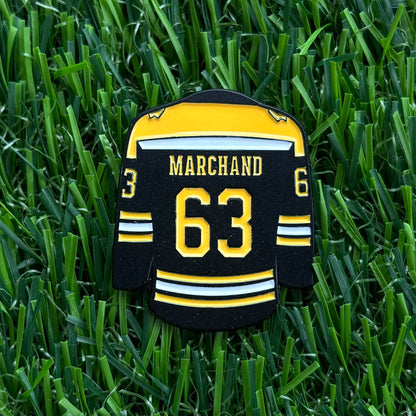 Sandybirds Golf Gear Marchand Ball Marker - Premium quality golf ball marker made of zinc alloy, designed in the shape of a Marchand jersey. A perfect accessory for golf enthusiasts looking to add a touch of style and precision to their game.