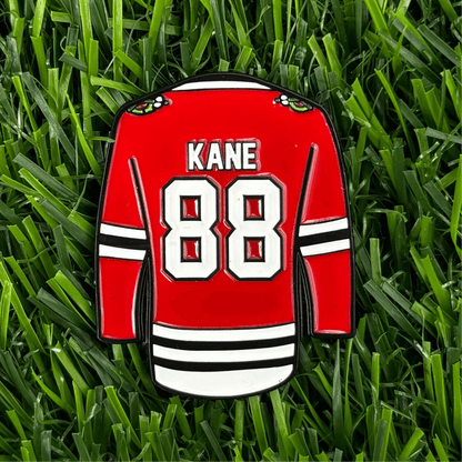 Patrick Kane golf ball marker featuring jersey design on green grass, stylish and durable golf accessory