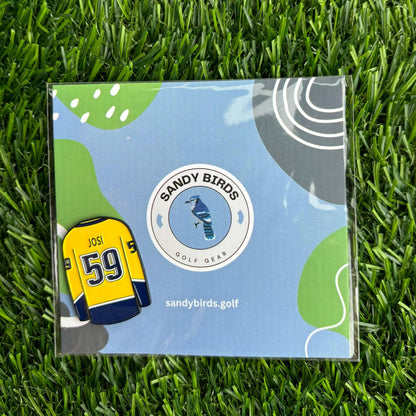 Roman Josi golf ball marker on grass, designed by Sandy Birds Golf Gear.