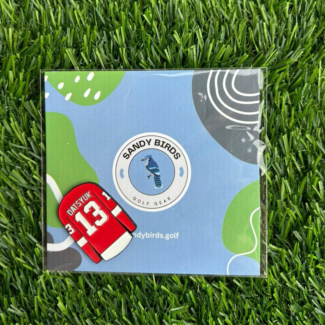 Pavel Datsyuk Golf Ball Marker on grass with Sandy Birds packaging