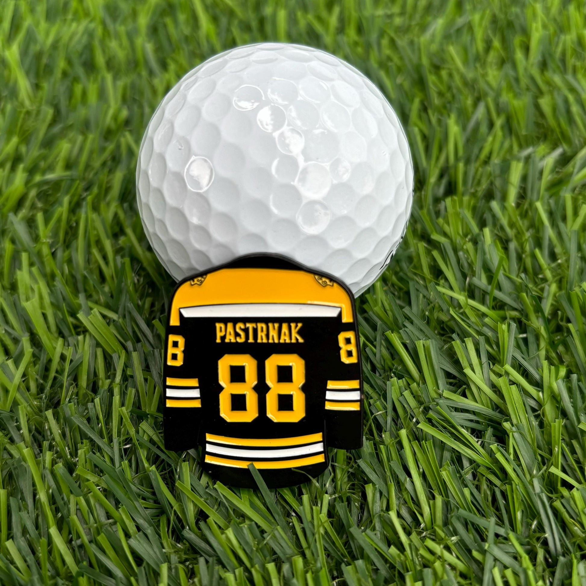 David Pastrňák golf ball marker on grass with hockey jersey design