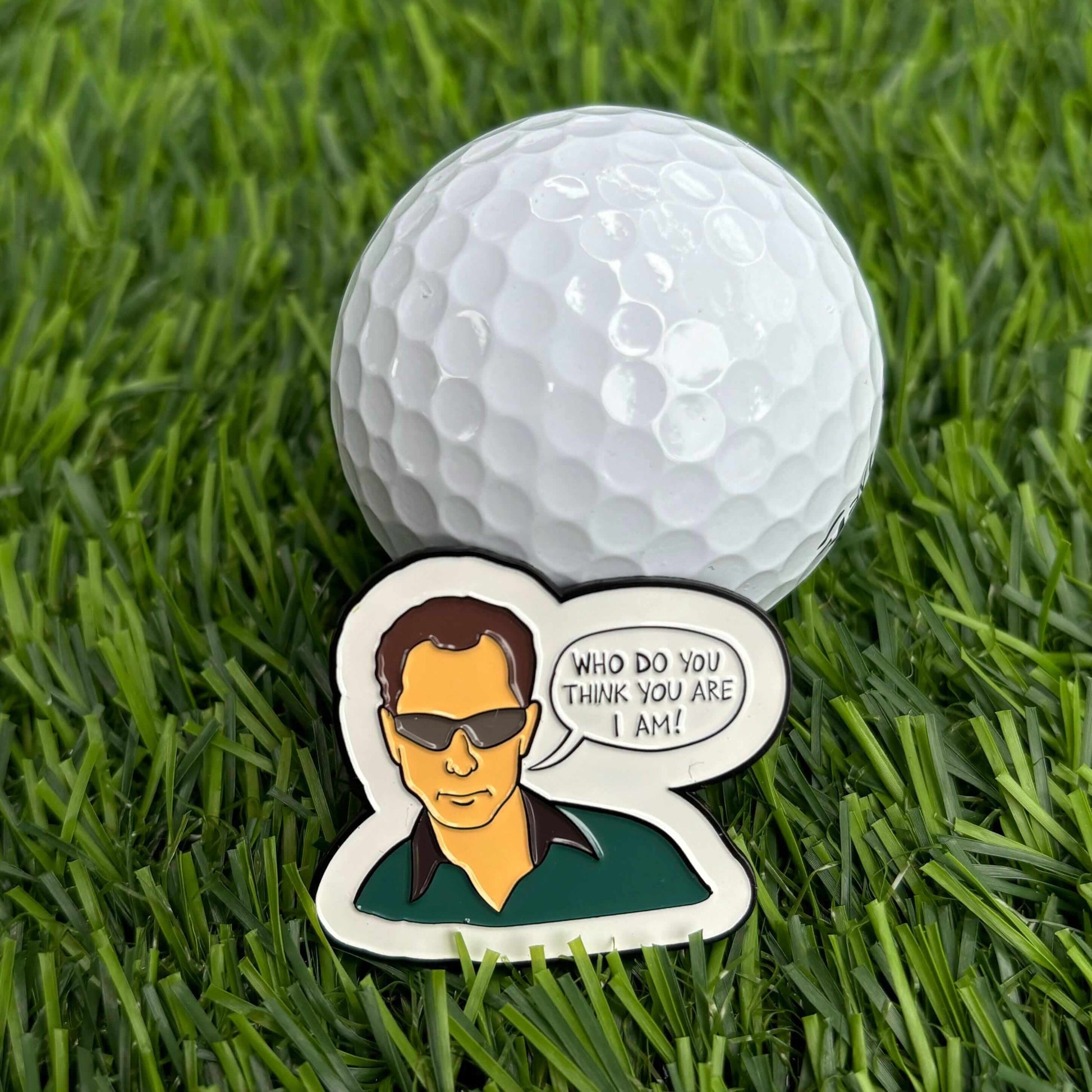 "Who Do You Think You Are I Am!" golf ball marker on grass with golf ball, durable custom marker for golfers, unique golfing accessory