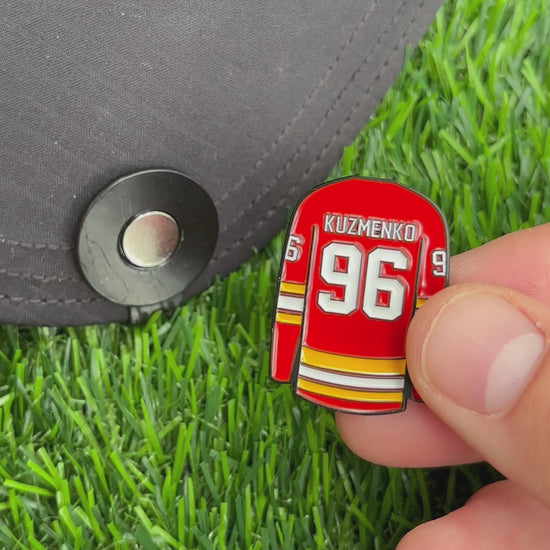 Sandybirds Golf Gear Kuzmenko Ball Marker - Premium quality golf ball marker made of zinc alloy, designed in the shape of a Kuzmenko jersey. A perfect accessory for golf enthusiasts looking to add a touch of style and precision to their game.