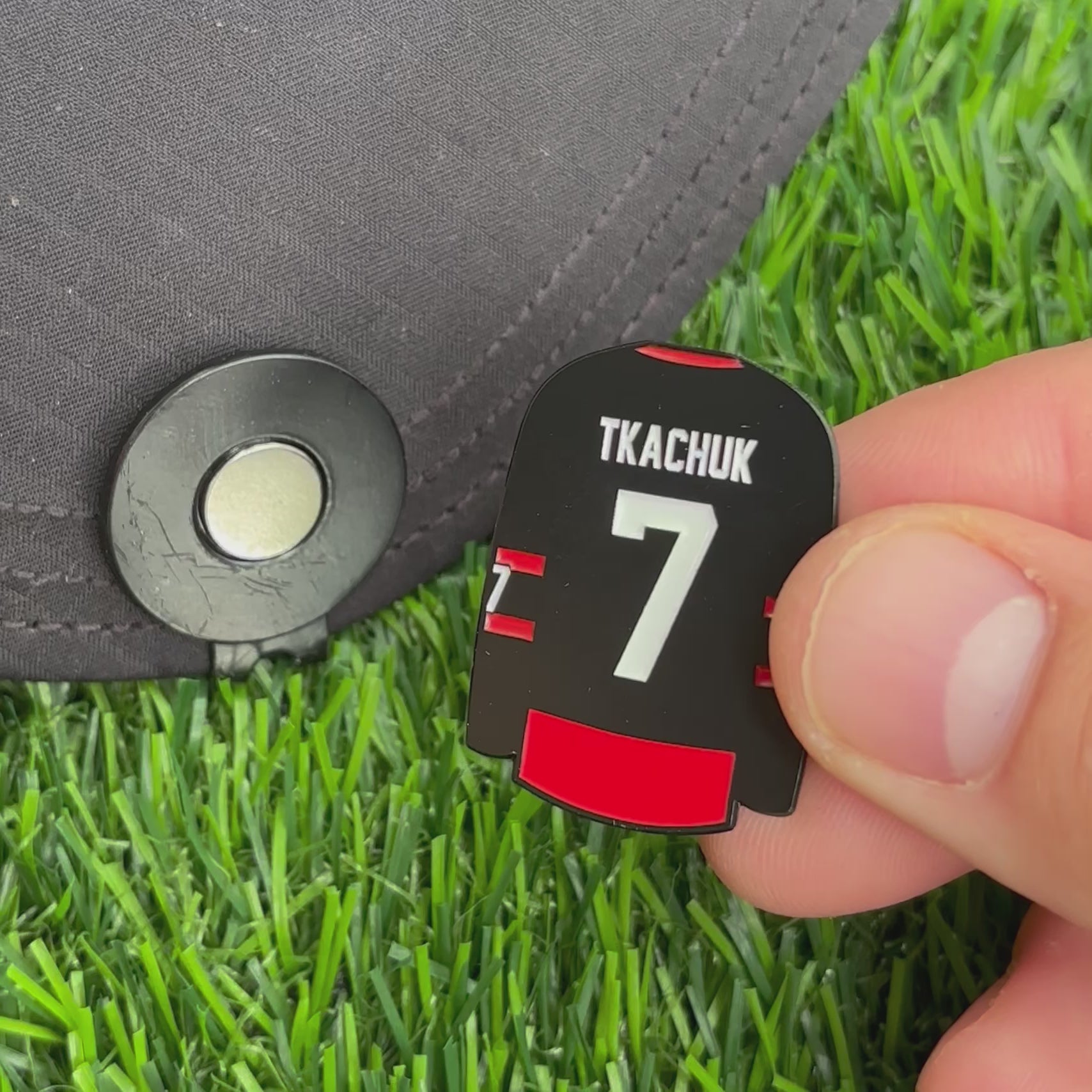 Sandybirds Golf Gear Tkachuk Ball Marker - Premium quality golf ball marker made of zinc alloy, designed in the shape of a Tkachuk jersey. A perfect accessory for golf enthusiasts looking to add a touch of style and precision to their game.